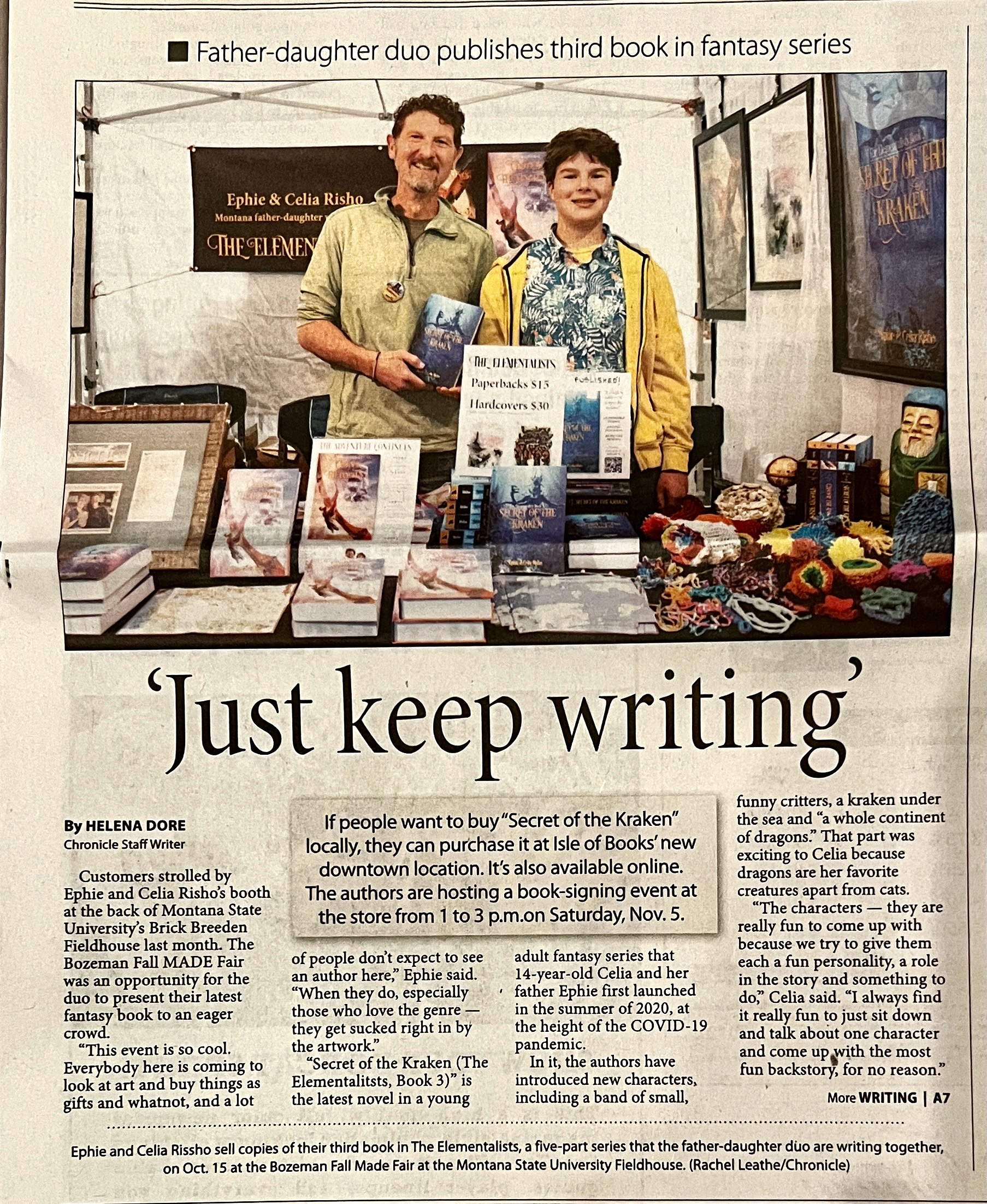 Newspaper feature in the Bozeman Daily Chronicle titled 'Just keep writing,' with a photo of Ephie and Blue at a book-signing table